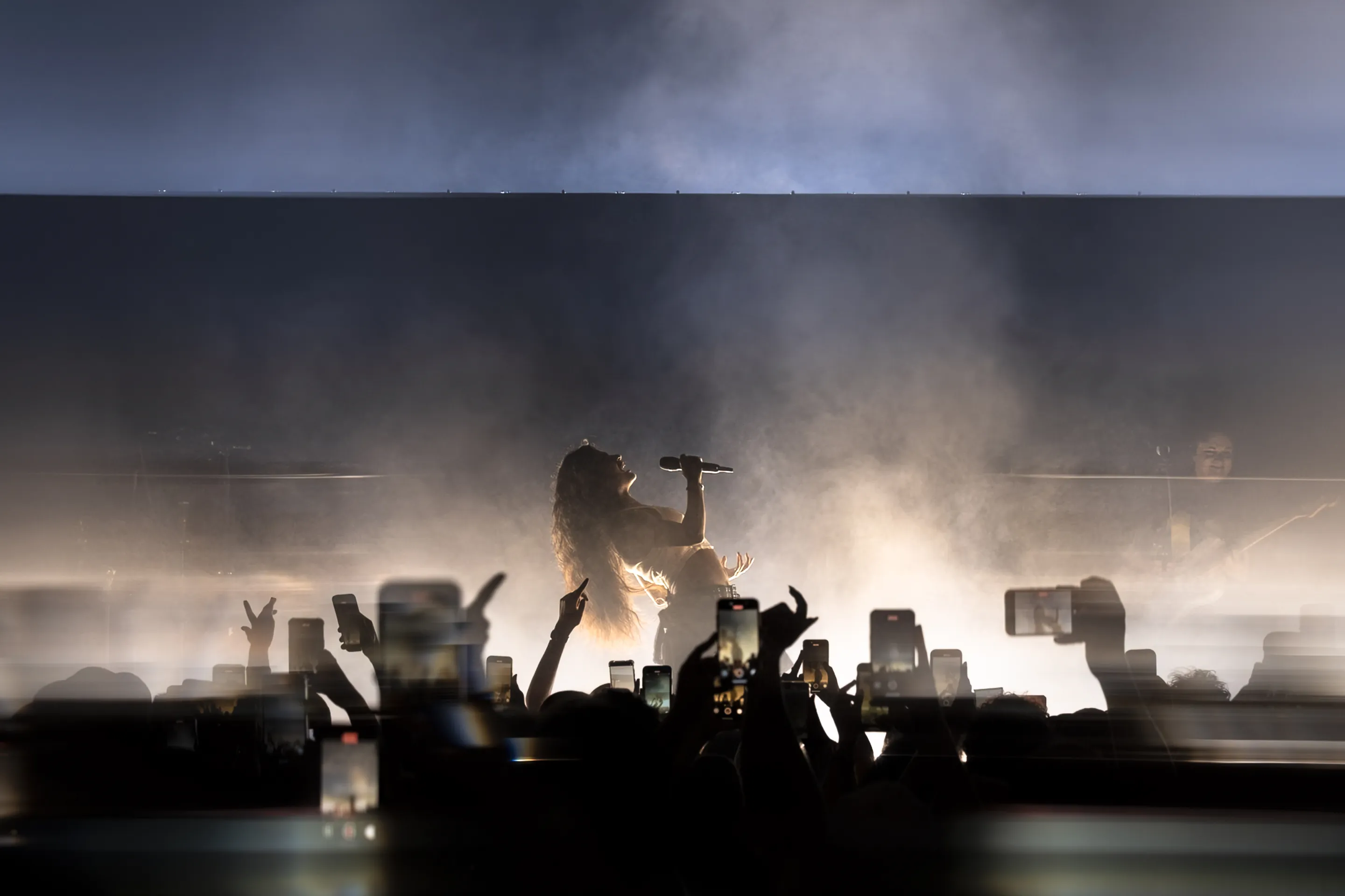 electronic music, Musicians photography featuring immersive visuals, pulsating energy, and audience interaction at a concert.