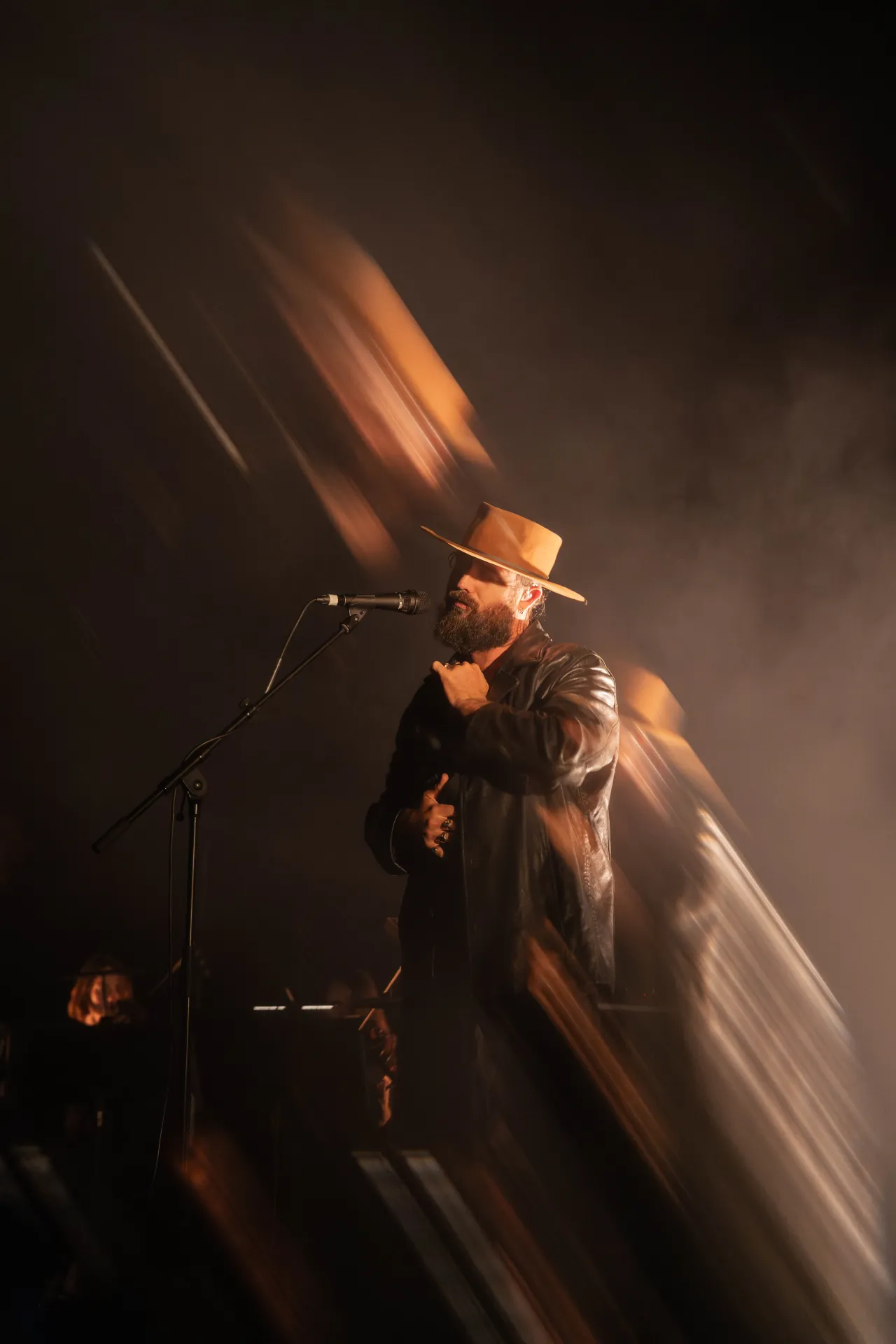 ry x, live performance, indie pop electronica artist, playing guitar with immersive lighting.