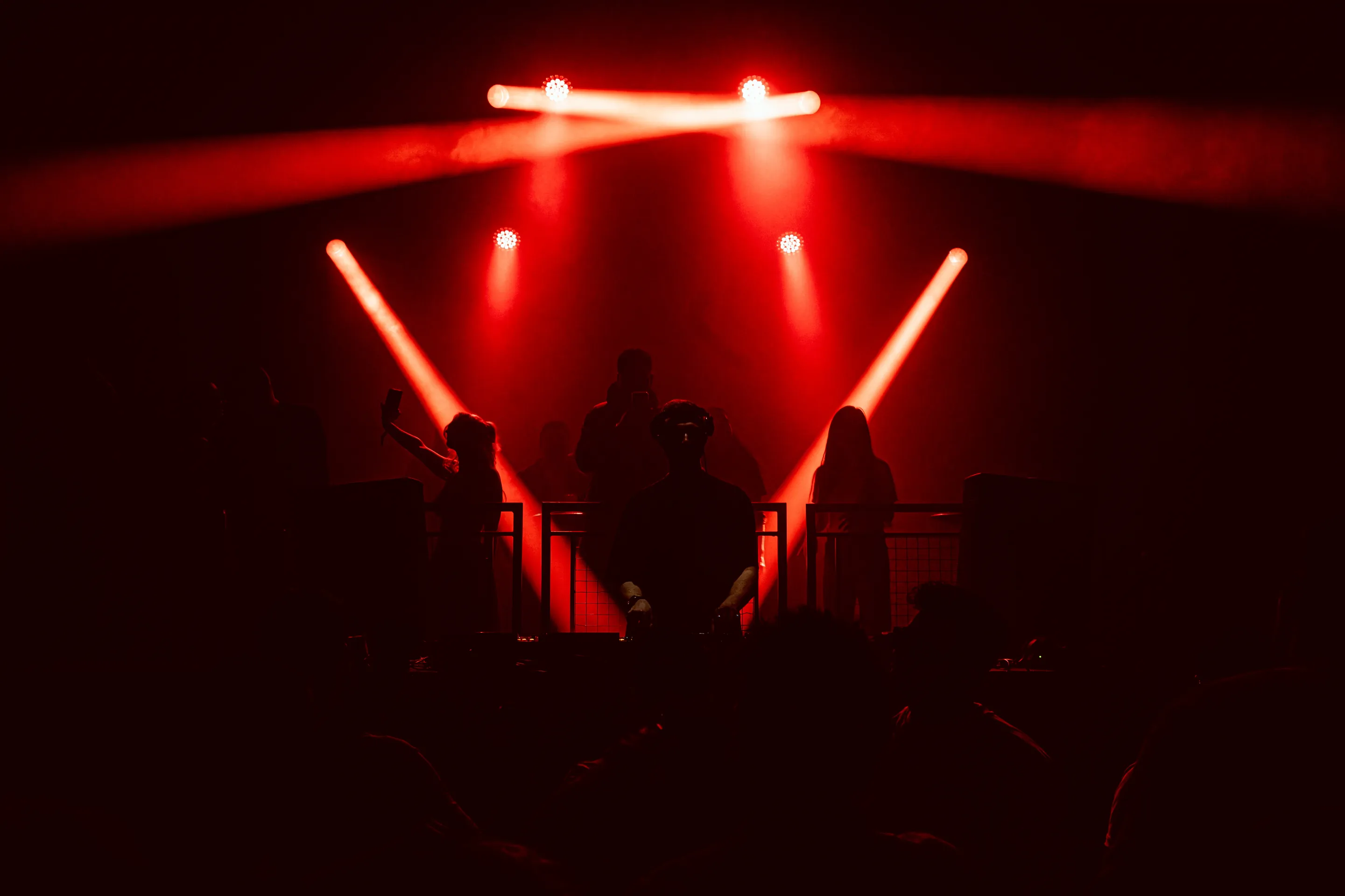 Live concert photography capturing musicians performing on stage with dynamic lighting and energetic crowd engagement.