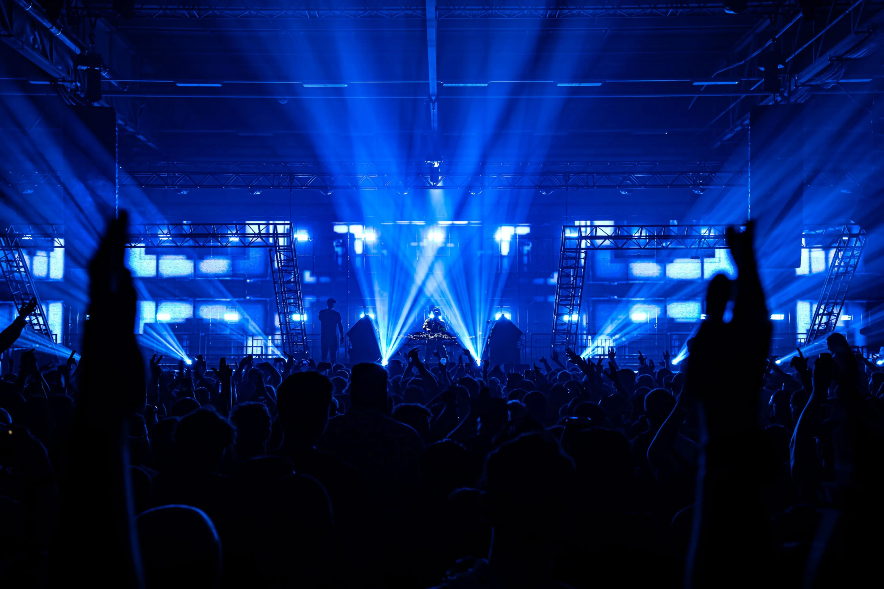 DJ set photography featuring immersive visuals, pulsating energy, and audience interaction at a music festival.